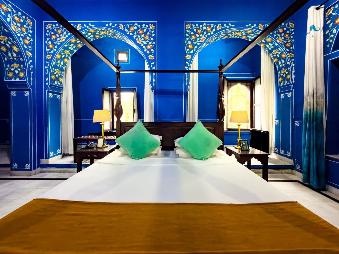Courtyard Room — blue painted room with four-poster bed
