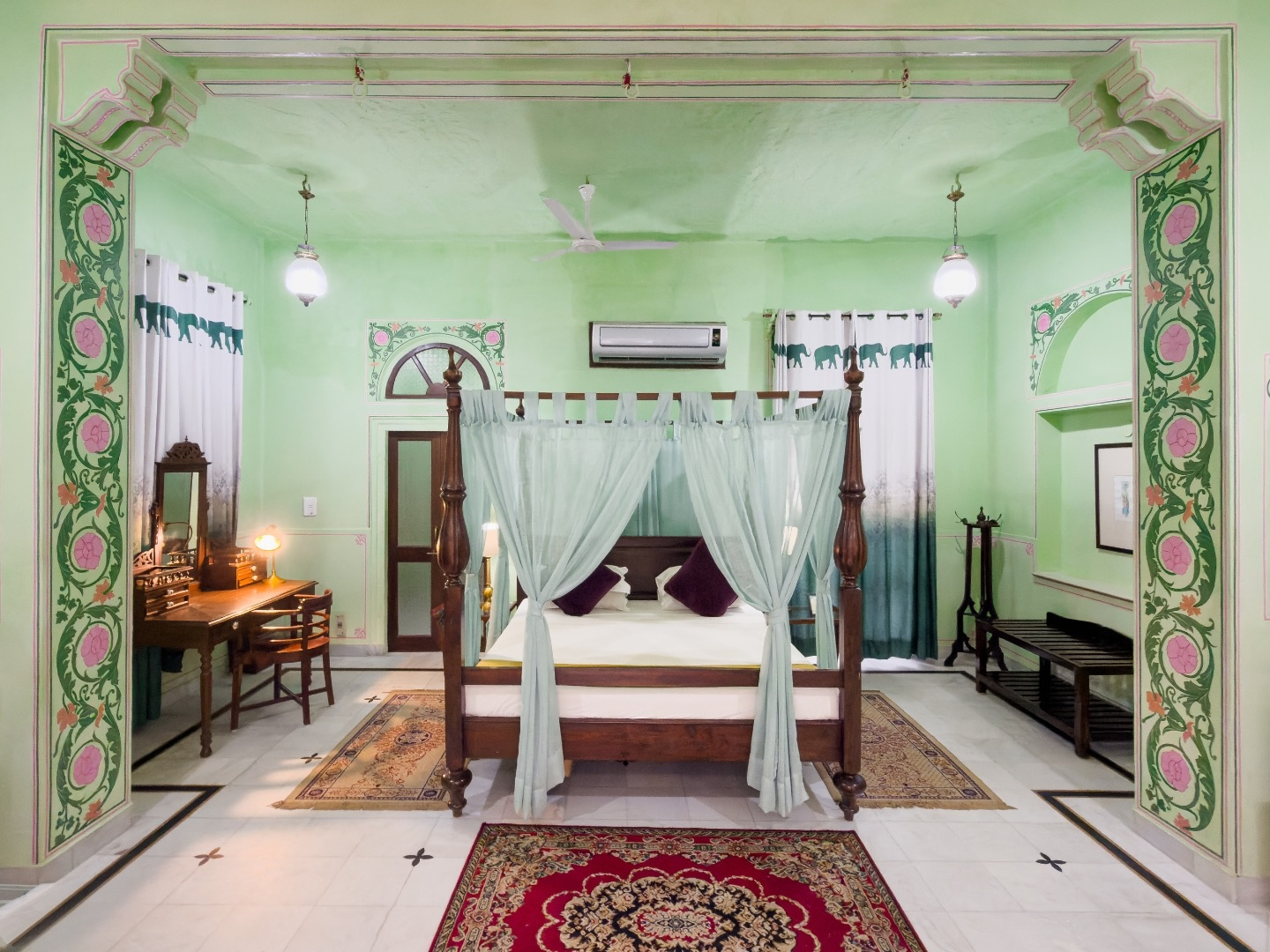 Courtyard Room — mint green room with canopy bed and painted pillars