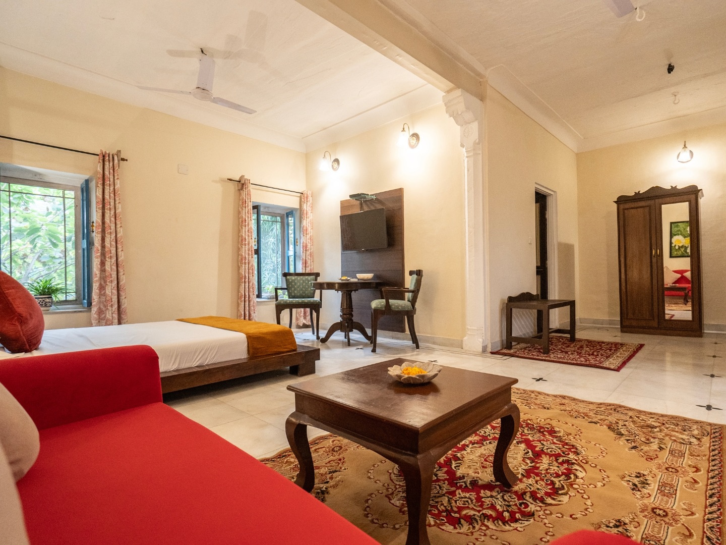 Heritage Deluxe — spacious room with sofa, coffee table and writing desk