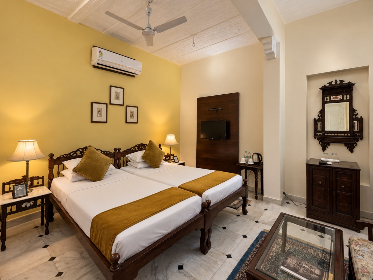 Heritage Standard — twin beds with golden bedspreads and carved side table
