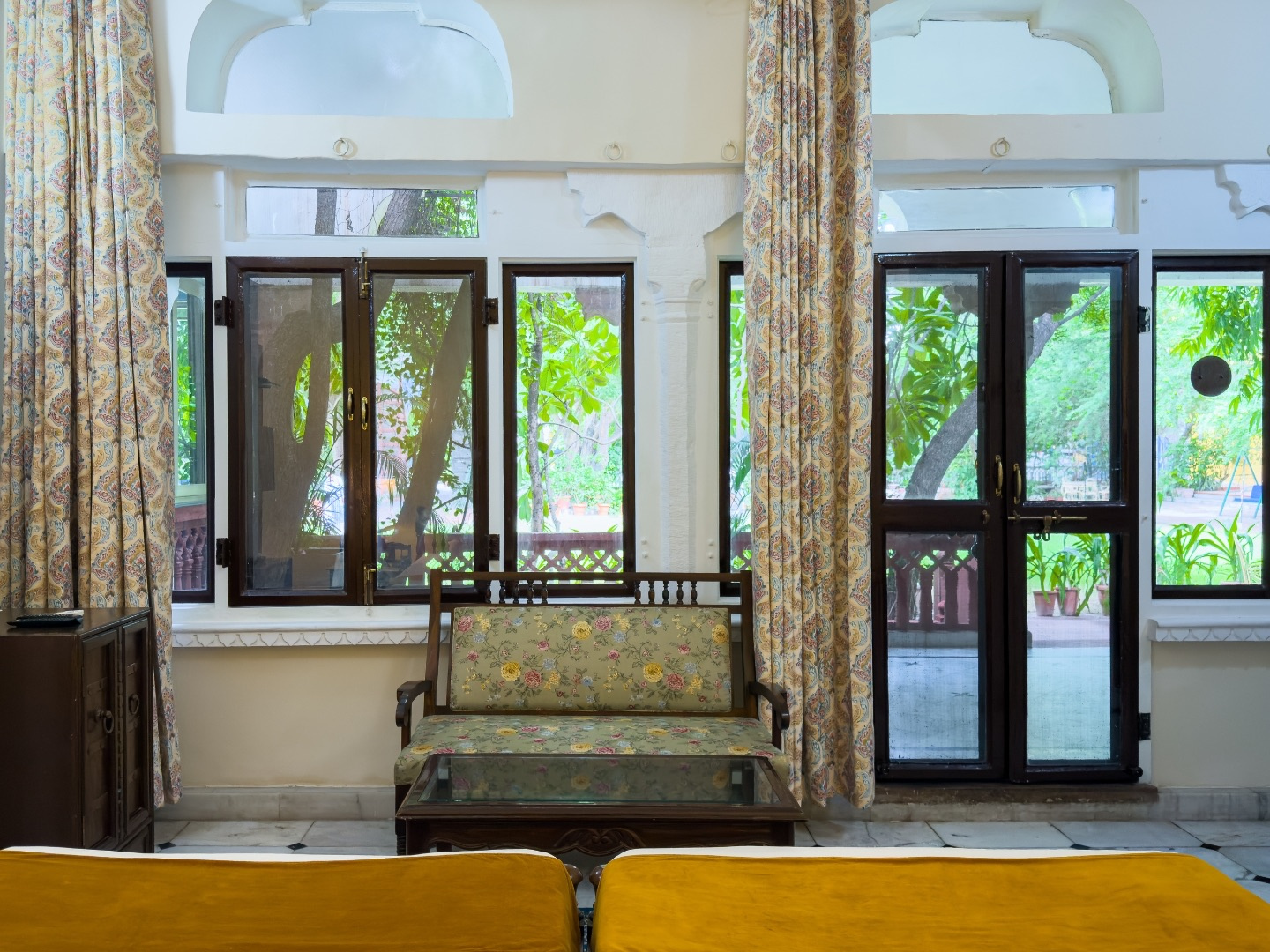 Heritage Standard — floral sofa by windows overlooking the gardens