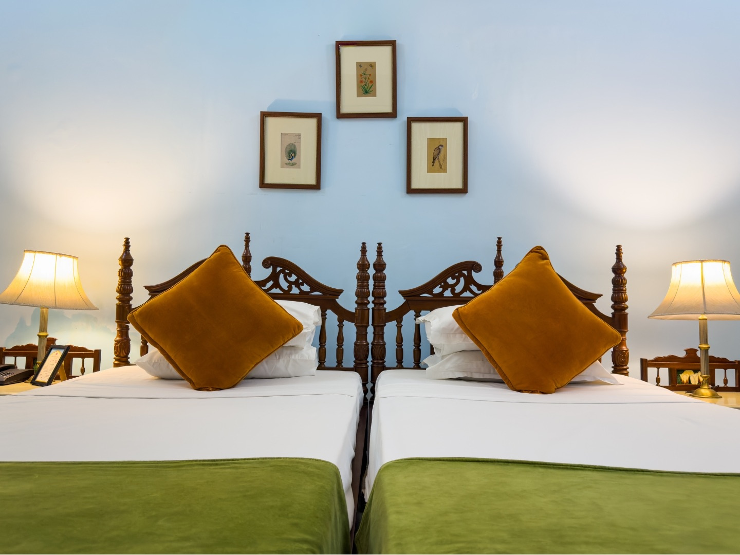 Heritage Standard — twin beds with carved headboards and green bedding