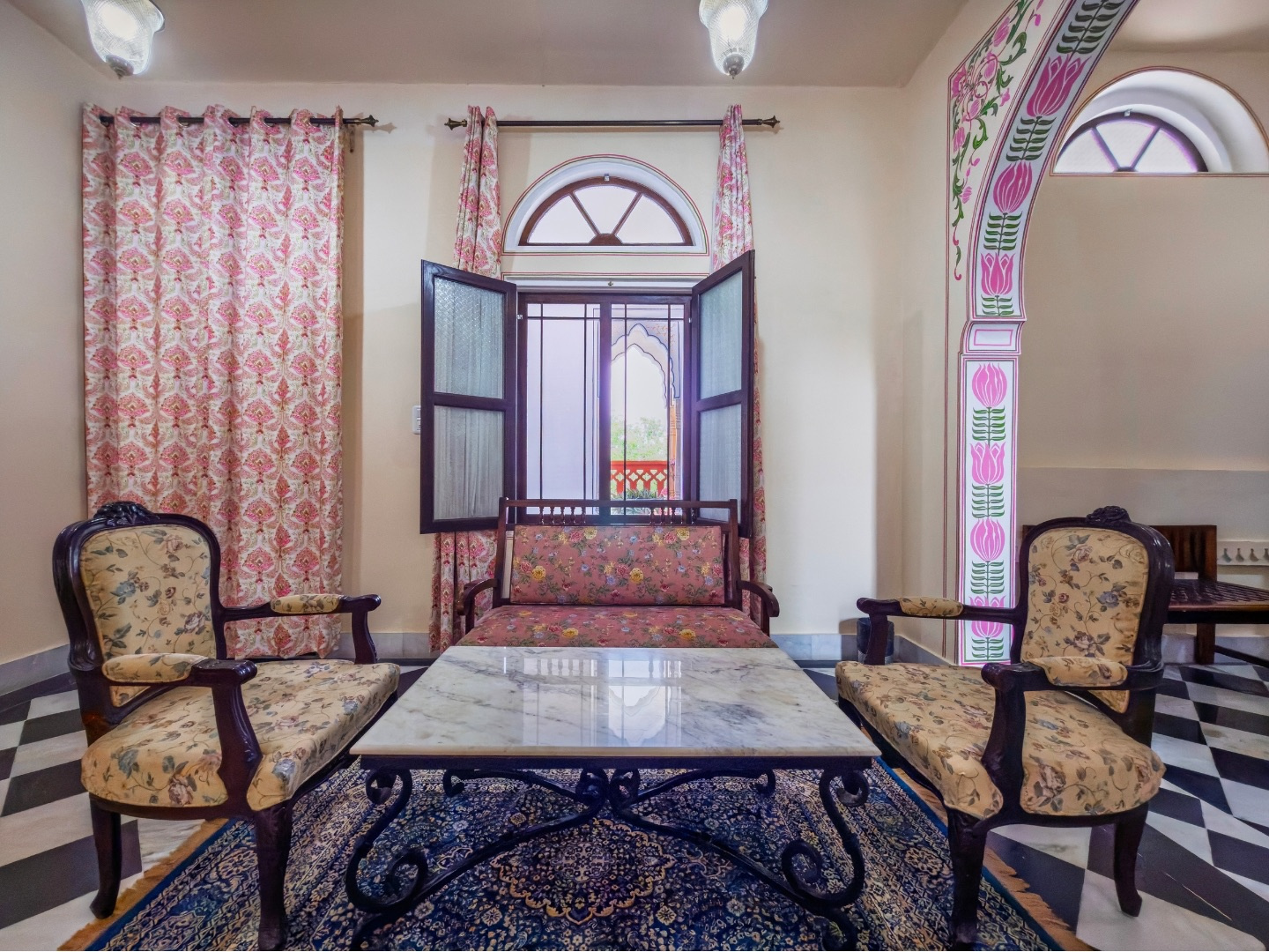 Palace Room — sitting area with cane chairs and marble table